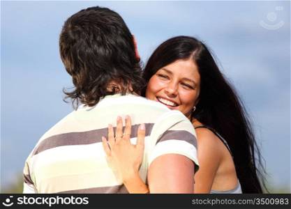 man and woman hug sky on background