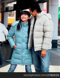 Man and woman in coats on street