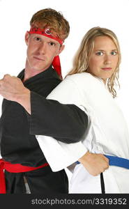 Man and woman in martial arts uniforms back to back