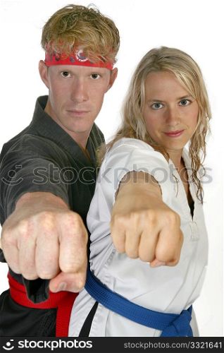 Man and woman in martial arts uniforms punching