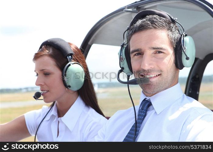 Man and woman in the cockpit of a light aircraft