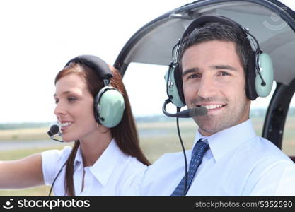 Man and woman in the cockpit of a light aircraft waiting for takeoff