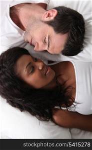 Man and woman laid in bed