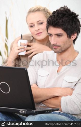 man and woman looking at a laptop