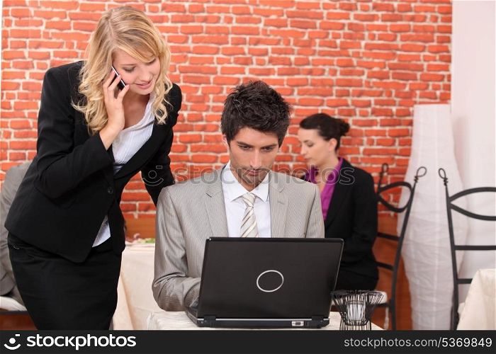 Man and woman looking at a laptop computer