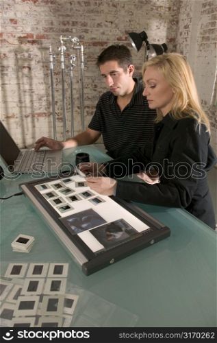 Man and Woman Looking at Slides