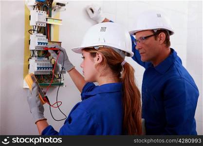 Man and woman measuring voltage