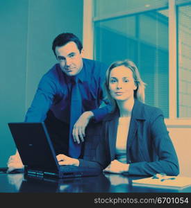 man and woman meeting at office desk