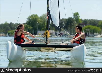 man and woman on a sailing boat
