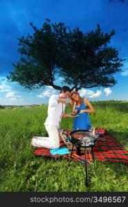 man and woman on picnic in green grass