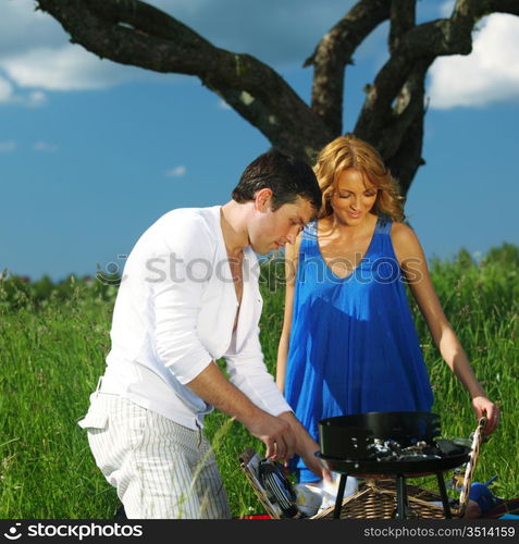 man and woman on picnic in green grass