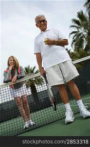 Man and woman on tennis court