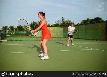 Man and woman on tennis training, outdoor court. Active healthy lifestyle, people play sport game, fitness workout with racquets. Man and woman on tennis training, outdoor court