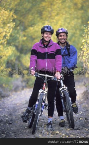 Man and Woman Posing on Mountain Bikes