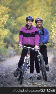 Man and Woman Posing on Mountain Bikes