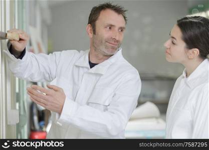 man and woman prepare for painting a room