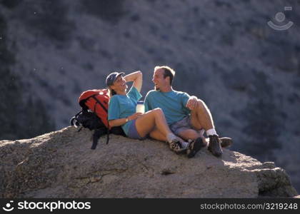 Man and Woman Resting on a Rock