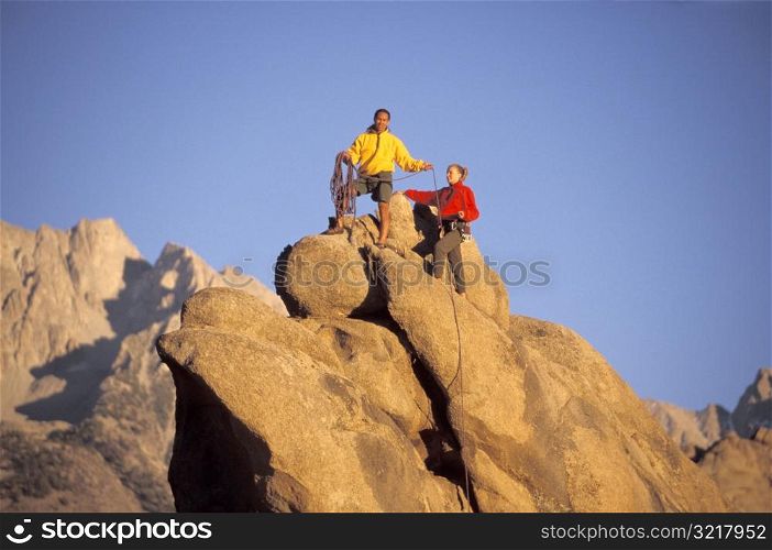 Man and Woman Rock Climbing