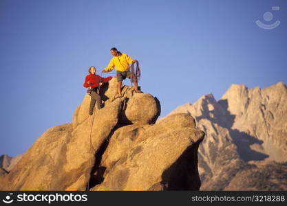 Man and Woman Rock Climbing