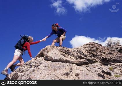 Man and Woman Rock Climbing