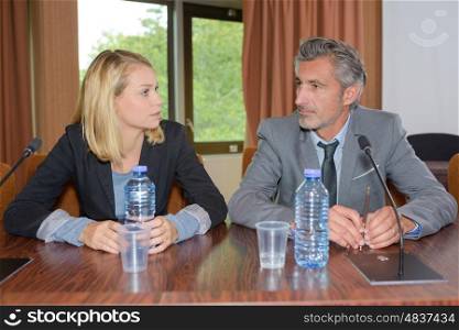 Man and woman sat at conference desk