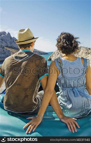 Man and woman sitting on car
