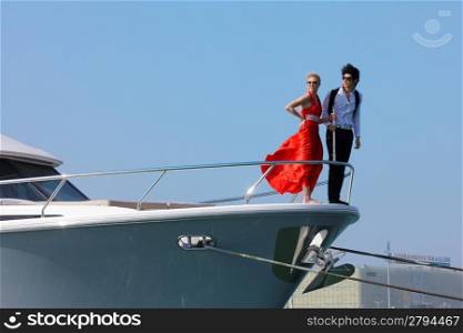 Man and woman stood on bow of boat