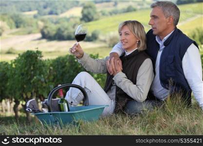 Man and woman tasting wine in a vineyard