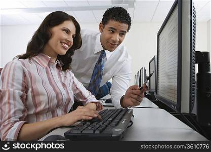 Man and woman using computer together