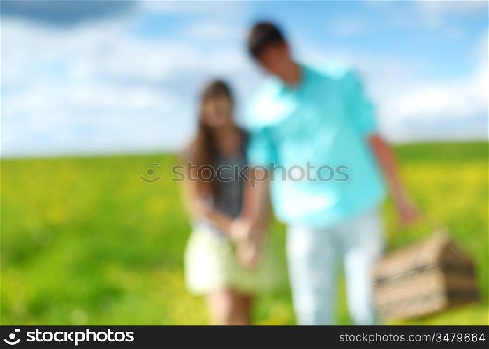 man and woman walk on picnicdesfocused
