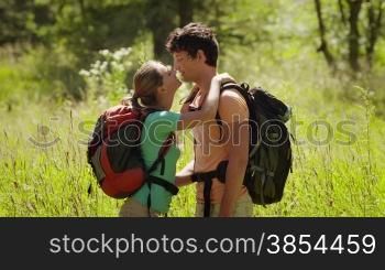 Man and woman walking during excursion in the forest, young couple kissing, hiking and trekking on mountains. Part 7 of 12