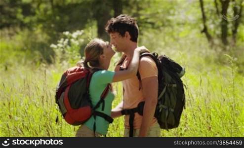 Man and woman walking during excursion in the forest, young couple kissing, hiking and trekking on mountains. Part 7 of 12