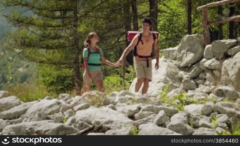 Man and woman walking during excursion on forest trail, young people hiking and trekking on mountain. Part 8 of 12