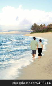 Man and Woman Walking Hand in Hand on Beach