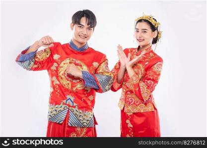 Man and woman wear Cheongsam suit glad the big win game in chinese new year day