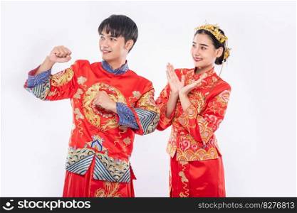 Man and woman wear Cheongsam suit glad the event will be occur on chinese new year