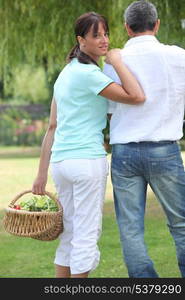 Man and woman with a basket of fruit