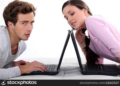 Man and woman with laptops