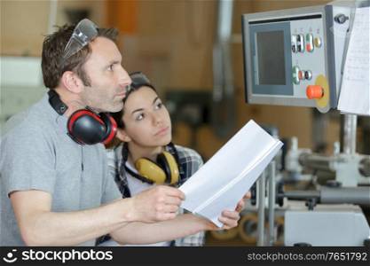 man and woman with machine cnc