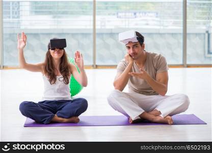 Man and woman with VR glasses meditating