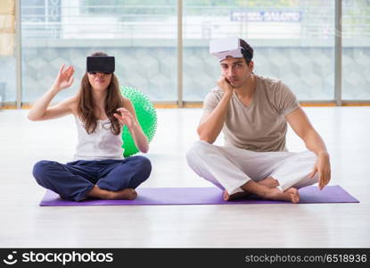 Man and woman with VR glasses meditating