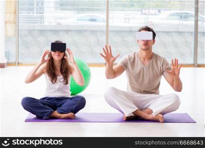 Man and woman with VR glasses meditating