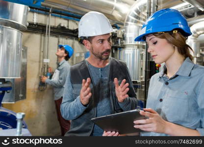 man and woman work in manufacturing factory