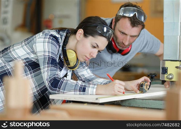 man and woman workers in the carpentry workshop