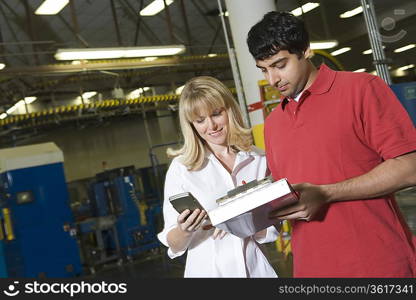 Man and woman working in newspaper factory