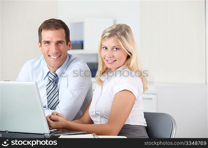 Man and woman working in the office on laptop computer