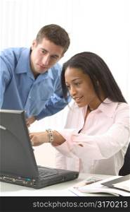 Man and Woman Working on a Laptop Together