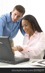 Man and Woman Working on a Laptop Together