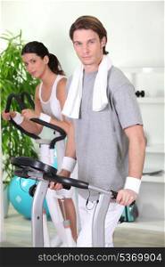 Man and woman working out in a gym