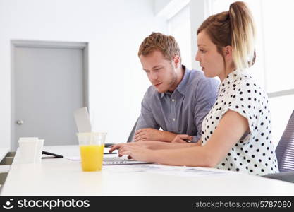 Man And Woman Working Together In Design Studio